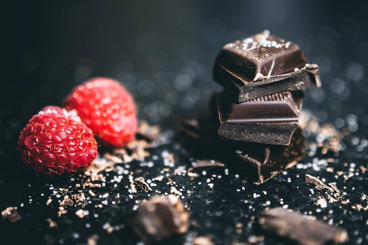 Dark chocolate squares and a raspberry.